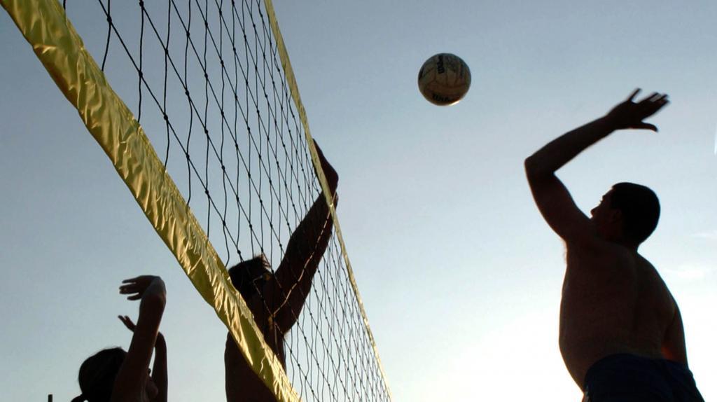 Player spiking a ball in beach volleyball